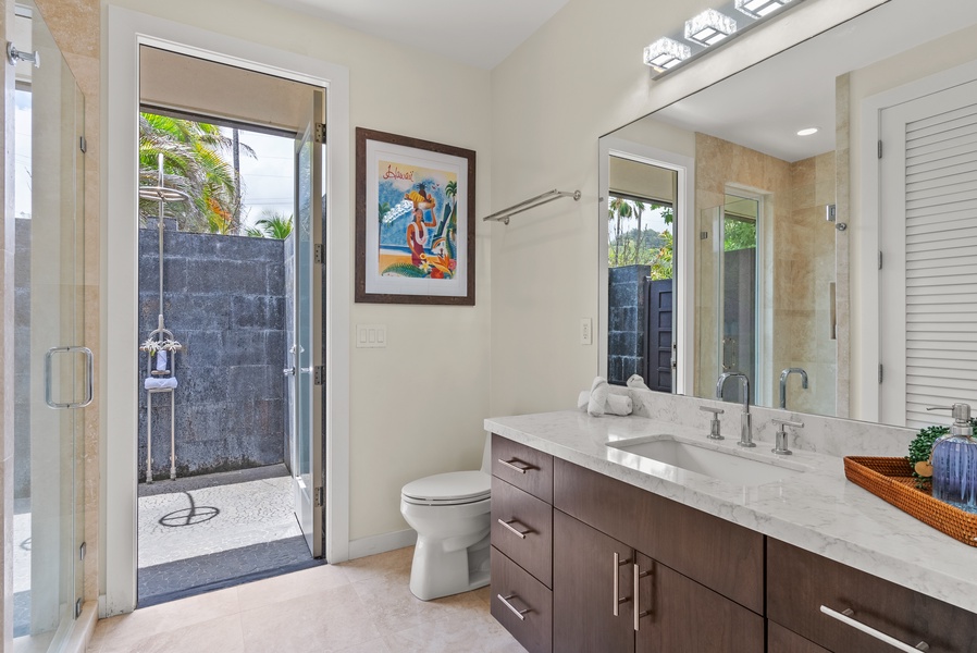 The ensuite bathroom has ample vanity space and an outdoor shower.