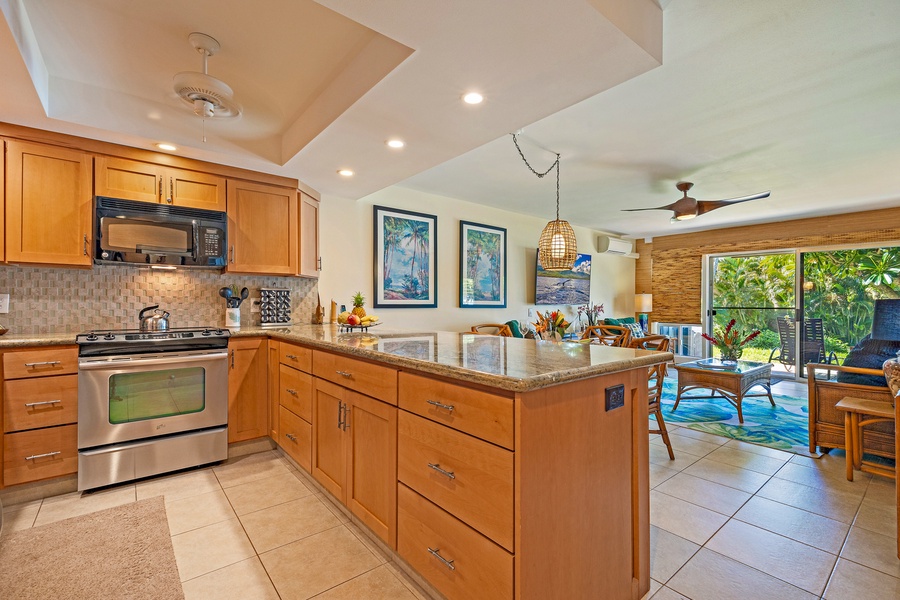 The kitchen's open layout, with a large granite island, provides plenty of counter space and flows seamlessly into the dining and living areas.