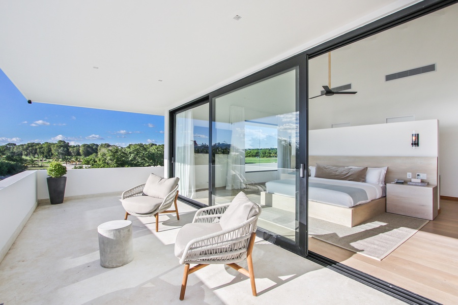 Relax on the private balcony with comfortable chairs and scenic views.