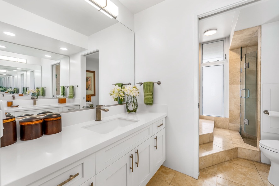 Relax in the spa-style soaking tub surrounded by warm tile and natural light—a rejuvenating space to unwind.