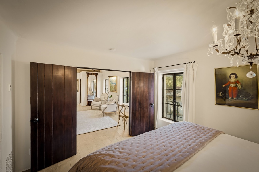 Your elegant bedroom features custom wardrobes and connects seamlessly to a charming sitting area perfect for relaxing.