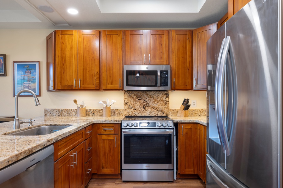 The fully equipped kitchen features stainless steel appliances and rich wood cabinetry.