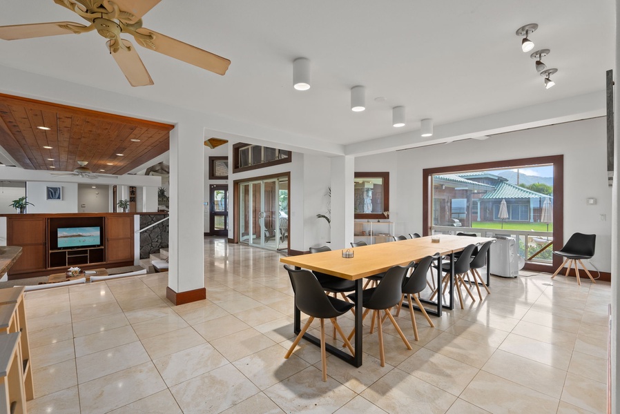 Contemporary dining space framed by natural light and tropical surroundings.