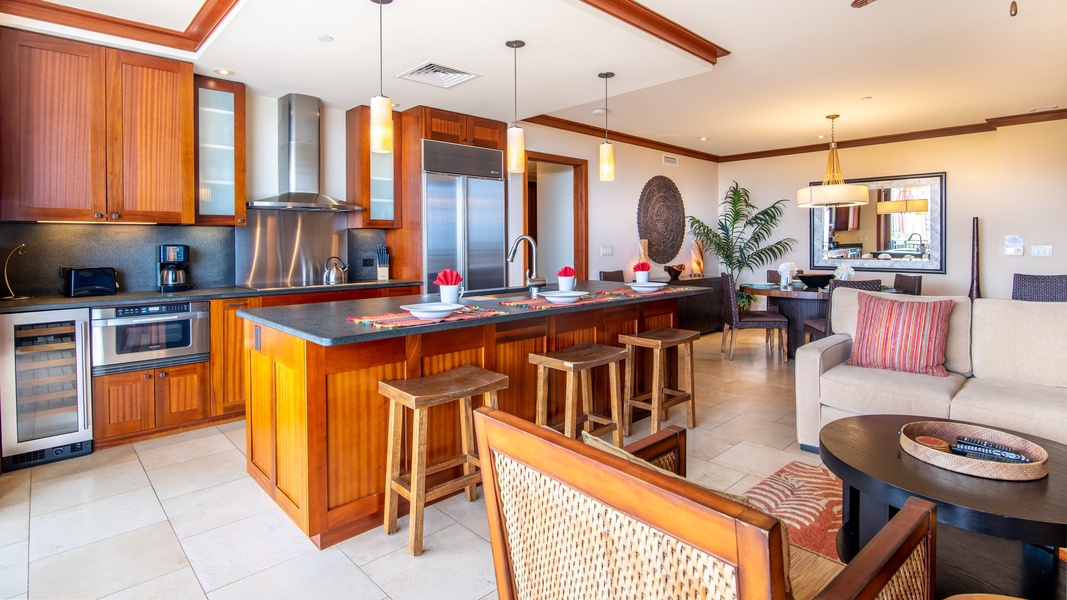 The kitchen is a chef's dream with stainless steel appliances and bar seating.