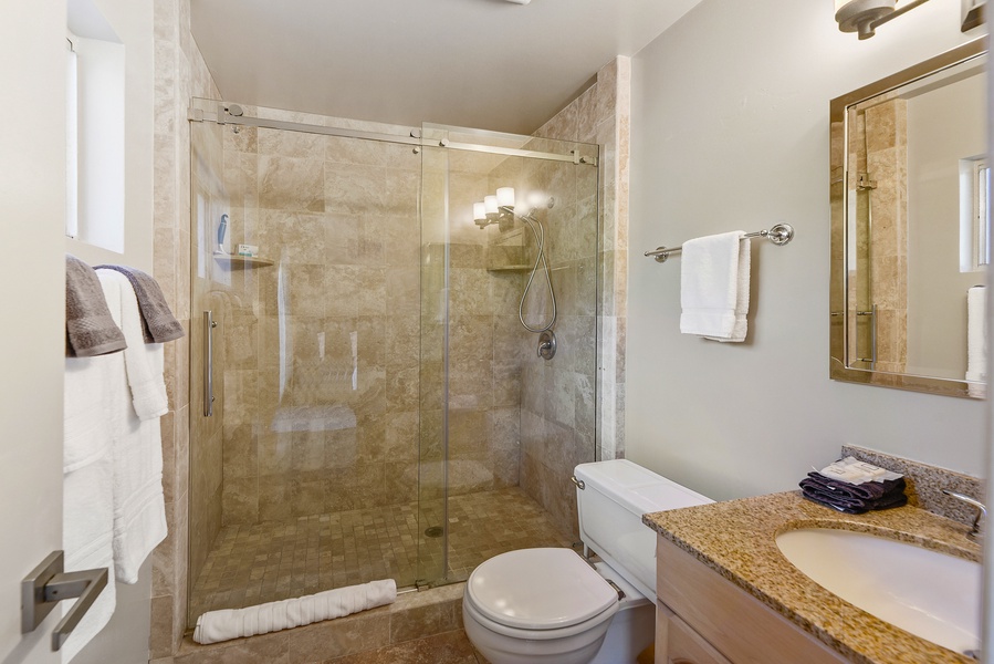 The primary ensuite bathroom comes with a glass enclosed walk-in shower.