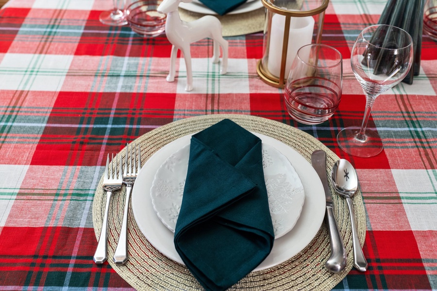 Close-up of a plaid table setting with festive accents, creating a cozy holiday atmosphere.