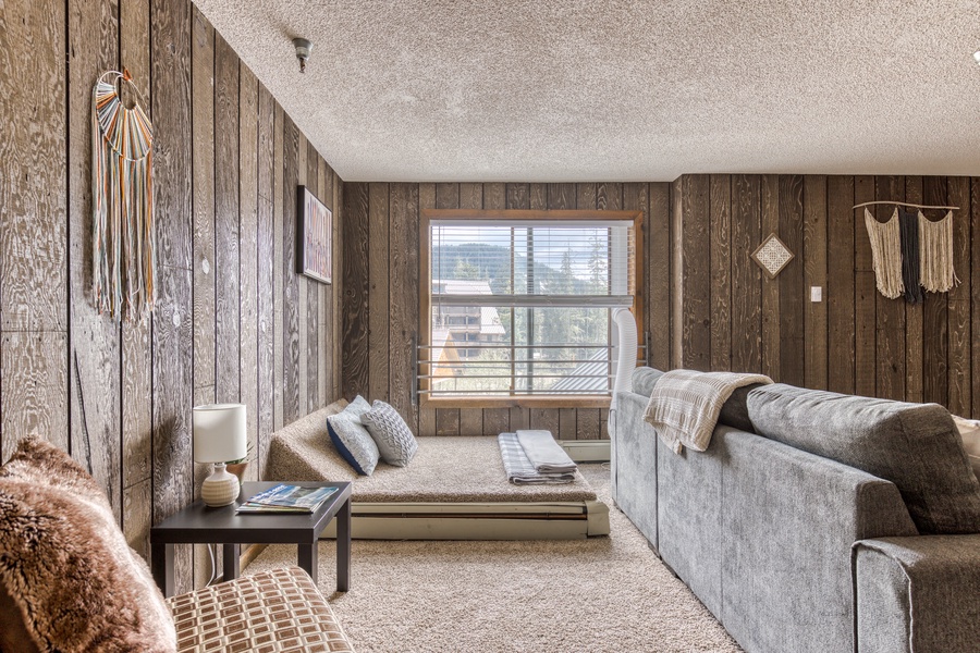 With an open-concept design, the central area of this cozy condo includes a living room furnished with a couch, a 55” Smart flatscreen TV, DVDs, and board games for easy entertainment