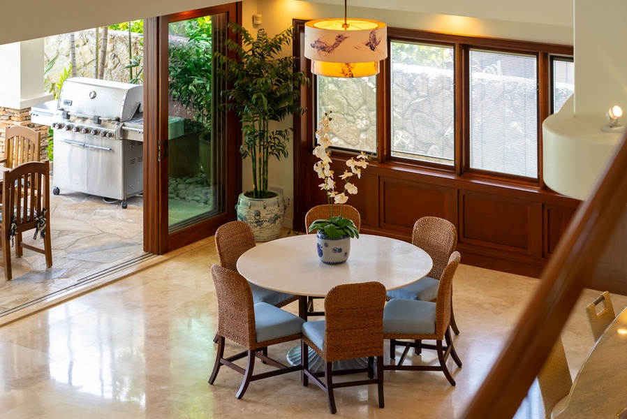 Gather around this inviting dining table where tropical breezes and garden views set the stage for your vacation meals, with a grill just steps away for alfresco cooking.