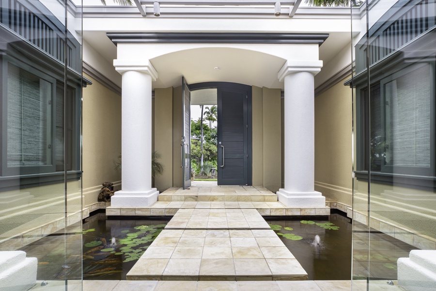 A grand entrance over a tranquil koi pond sets the tone for this serene island retreat.