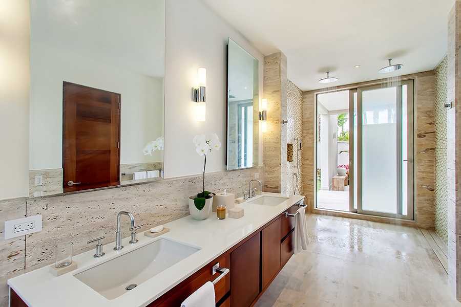 Dual vanity spaces leading to the stone shower.