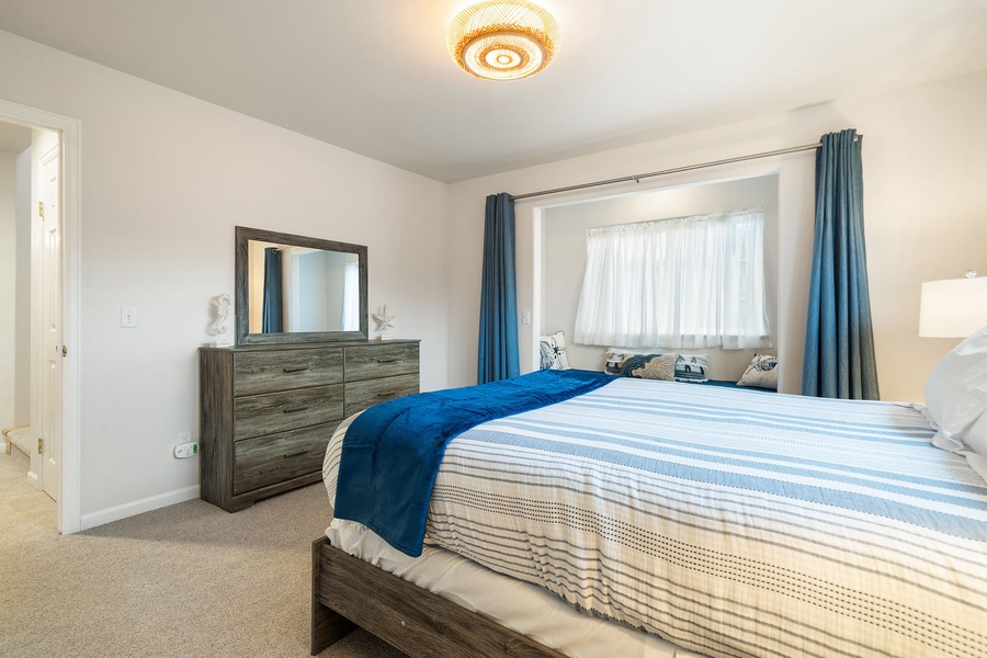 Sink into your comfortable bed with soft linens and enjoy the peaceful ambiance of your stylishly furnished bedroom retreat.