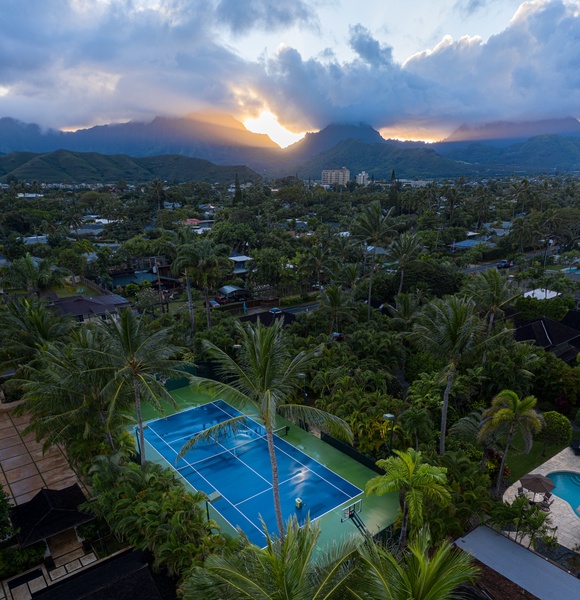 Stunning sunset backdrop over a vibrant pool area creates a magical ambiance.