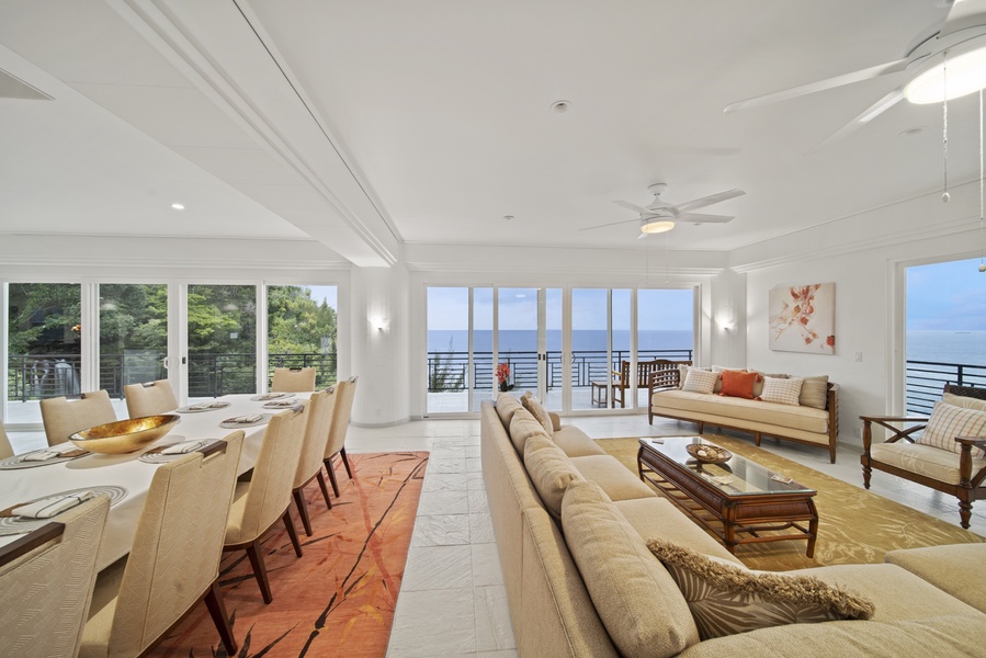 Great room with ample plush seating, wrap around deck and ocean views.