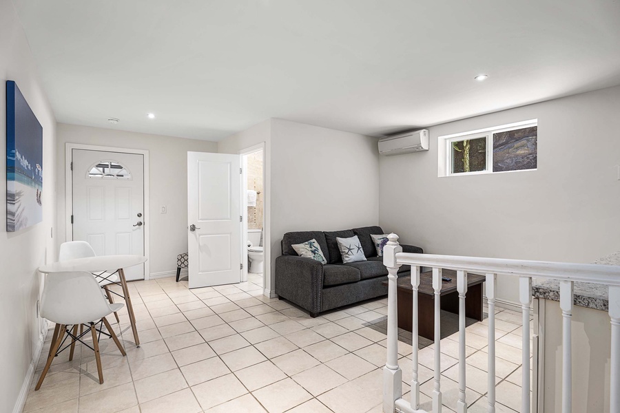 Downstairs media room equipped with A/C, Queen sleeper sofa, and attached bath