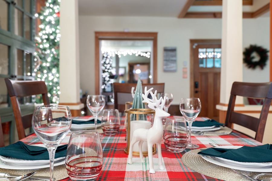 Plaid table runner and sparkling glassware creating a warm holiday dining experience.