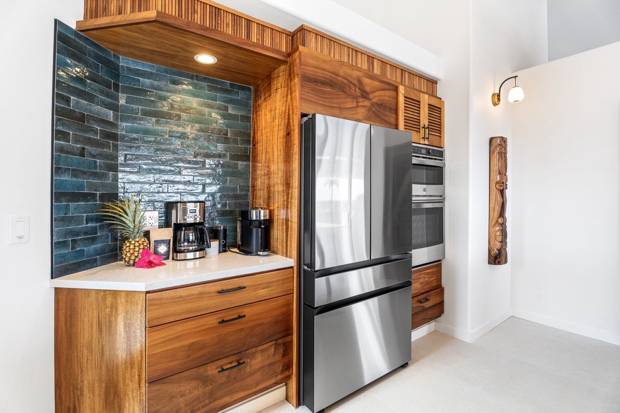 Coffee station with tropical flair and stainless appliances, where mornings begin with Kona brews and thoughtful design.