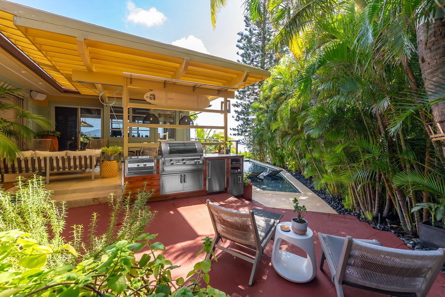 Covered grilling station with bar seating—ideal for island-style cookouts.