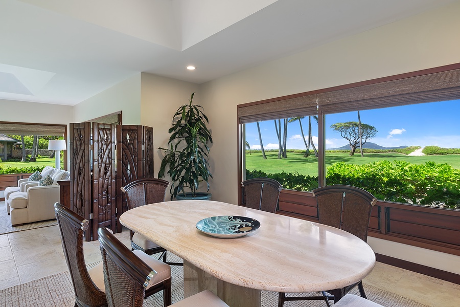 Dining area with a table that comfortably seats 6, featuring scenic views of the outdoors.