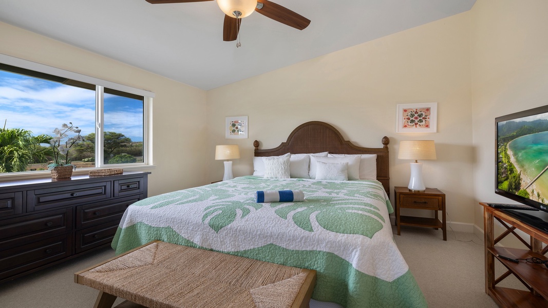 A bright and comfortable guest bedroom featuring a queen bed, ceiling fan, and soft linens—perfect for restful nights after island adventures.