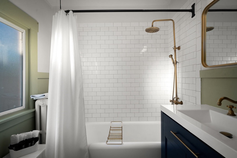 Start slow mornings in this airy bathroom with a soaking tub and rainfall-style shower.