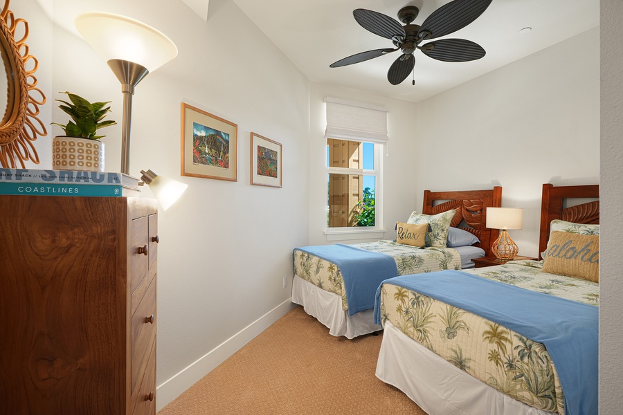 Comfortable twin bedroom with soft lighting and ceiling fan.