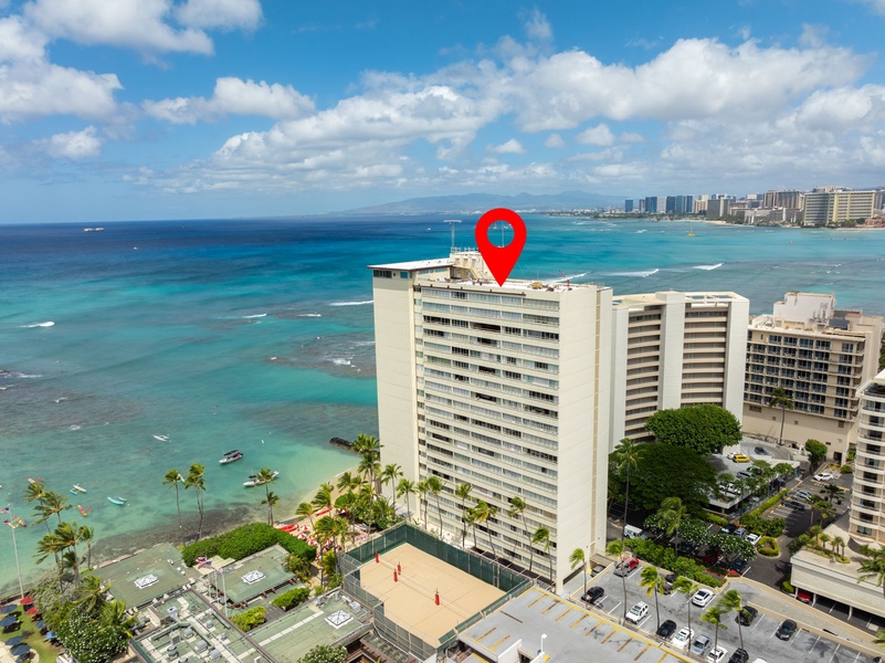 Aerial view of the beachfront condo with easy ocean access and proximity to city attractions.