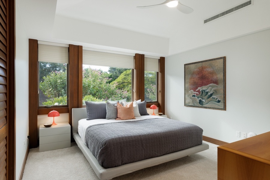 The second guest suite with a king bed on a floating bed frame, blending modern style with ultimate comfort.