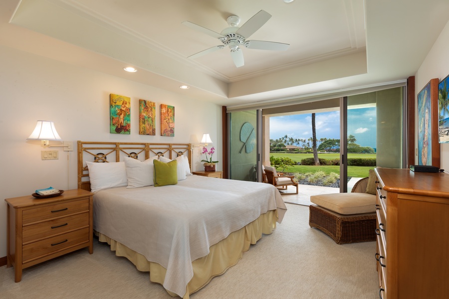 Drift off to sleep in this serene King bedroom where comforting breezes flow through sliding doors and lush garden views greet you each morning.