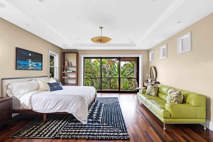 Large guest suite with California king bed, and tropical backdrop.