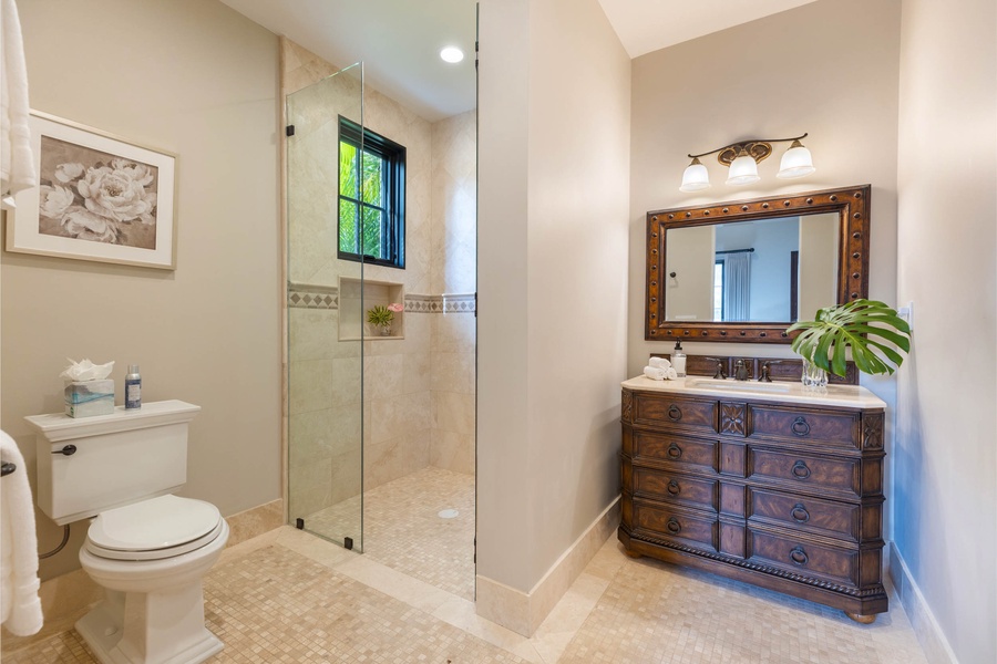 Modern bathroom with a glass walk-in shower, wooden vanity, and stylish finishes.