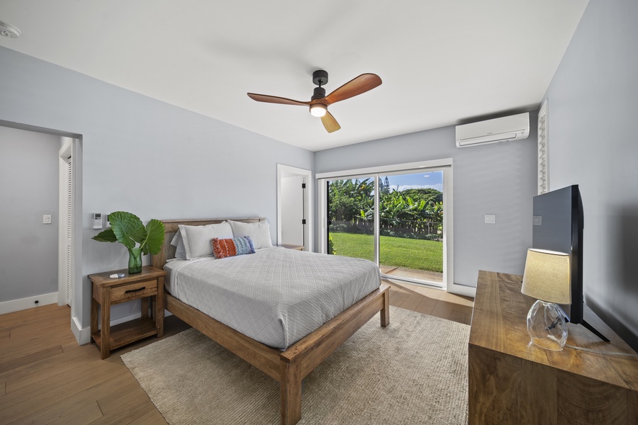 Bedroom 3 with queen bed, dresser, smart TV, and lanai access