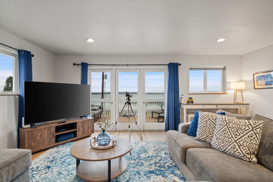 Unwind in your bright living room with comfy seating, modern entertainment center, and stunning water views from your private balcony.