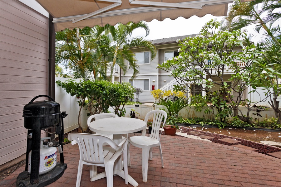 The tranquil lanai where you can dine al fresco and grill surrounded by lush greenery.