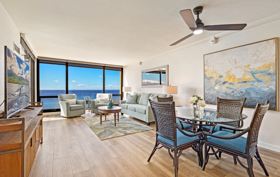 The living and dining area features floor-to-ceiling windows that offer breathtaking ocean views.