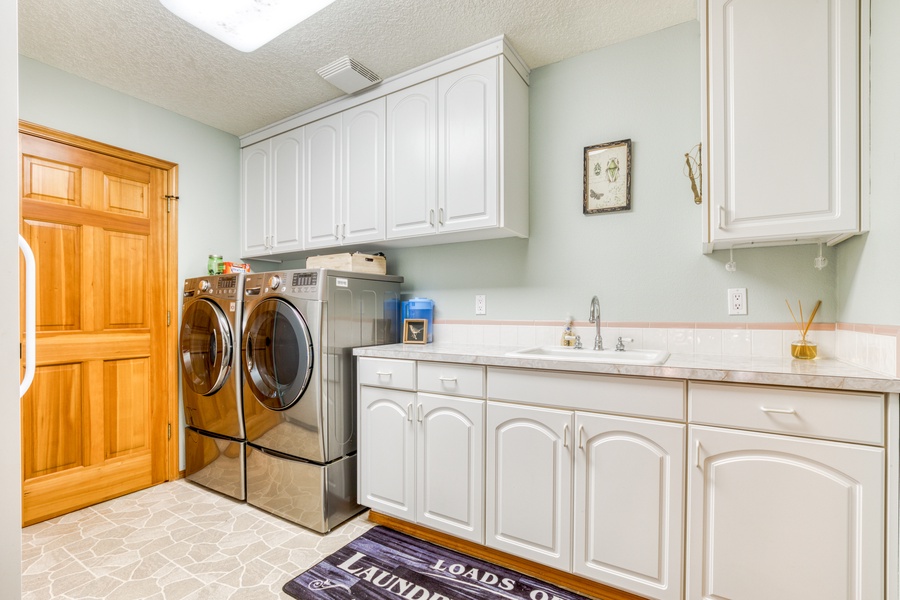Laundry room with washer and dryer down stairs