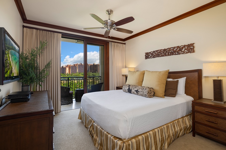 The primary guest suite offers direct lanai access, bringing the beauty of the tropical landscape indoors for a true Hawaiian escape.