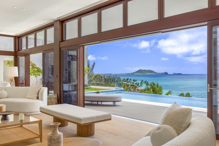 Immerse yourself in panoramic ocean views from every angle of the elegant living room.