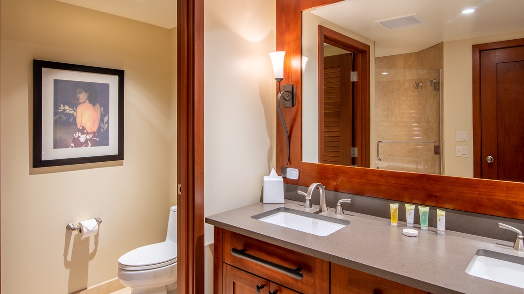 The primary guest bathroom has a double vanity and walk-in shower.