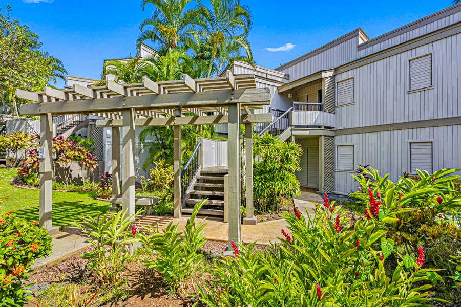 A beautifully landscaped path leads to the entrance of this tropical getaway, offering a peaceful and welcoming ambiance.