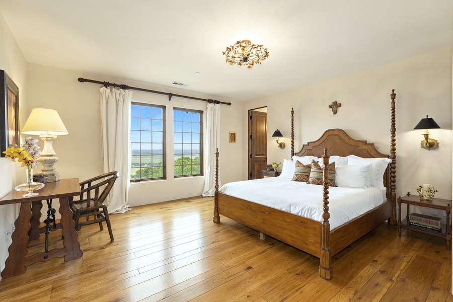 The first bedroom on the right, located on the second floor, is the primary suite and features a king bed, luxurious furnishings, and absolutely breathtaking views of the vineyards