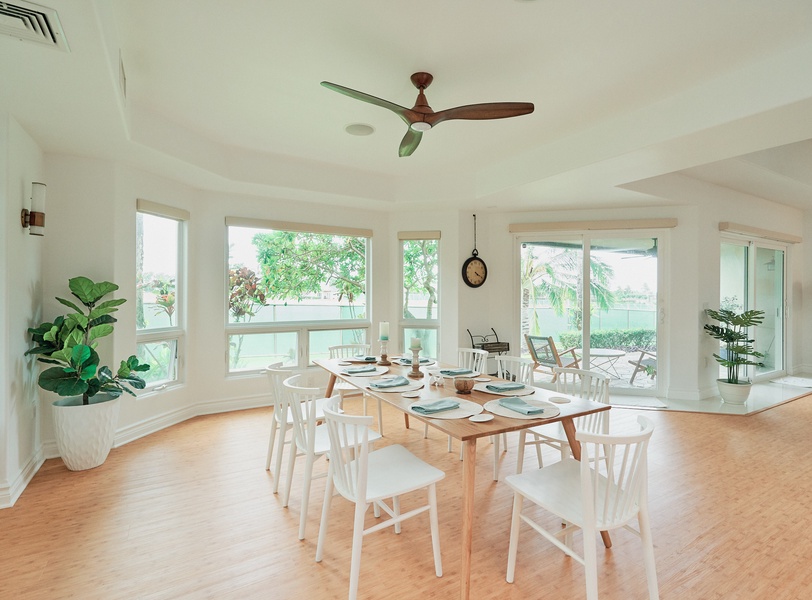 Your bright dining space features large windows and a ceiling fan, perfect for memorable meals with tropical garden views.