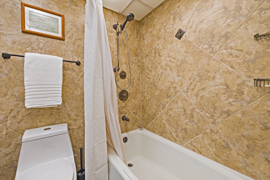Kaanapali Shores 544’s bathroom features a tiled shower and bath combo, perfect for relaxing.