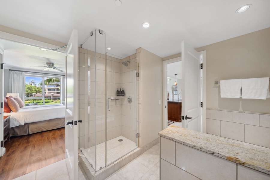 Refresh in Honua Kai Konea 204’s second bath with a sleek walk-in glass shower and bright natural light.