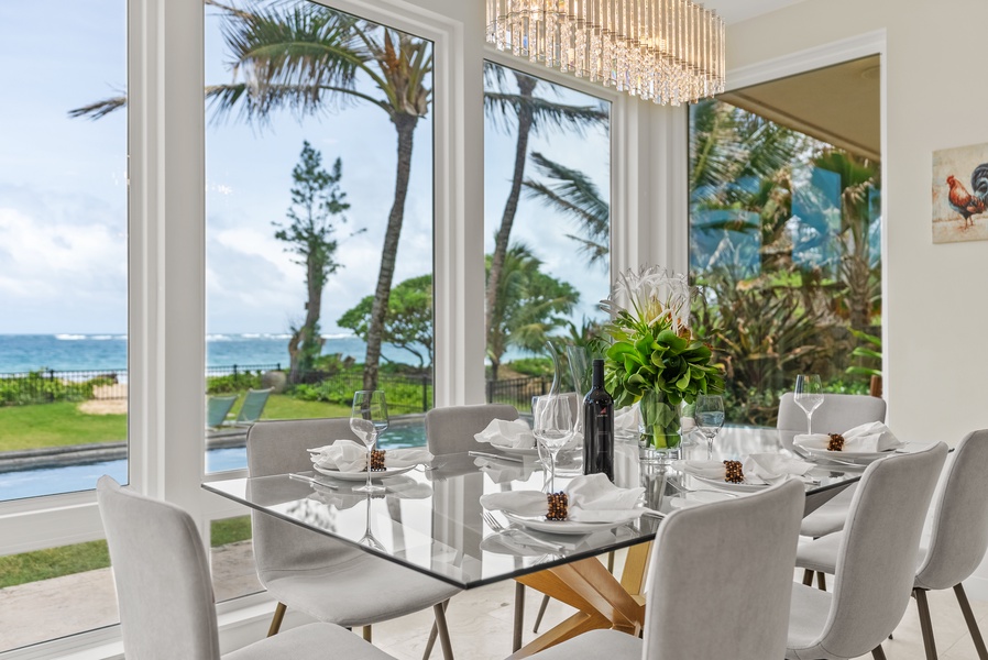 Dine with a view in the elegant dining area with large windows overlooking the ocean.