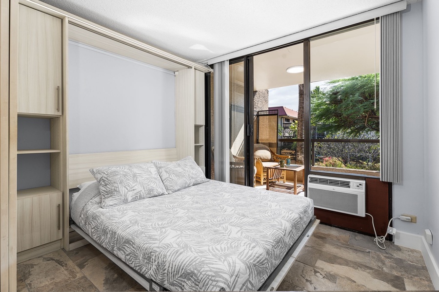 Secondary sleeping area with a comfortable Queen bed and patio access.