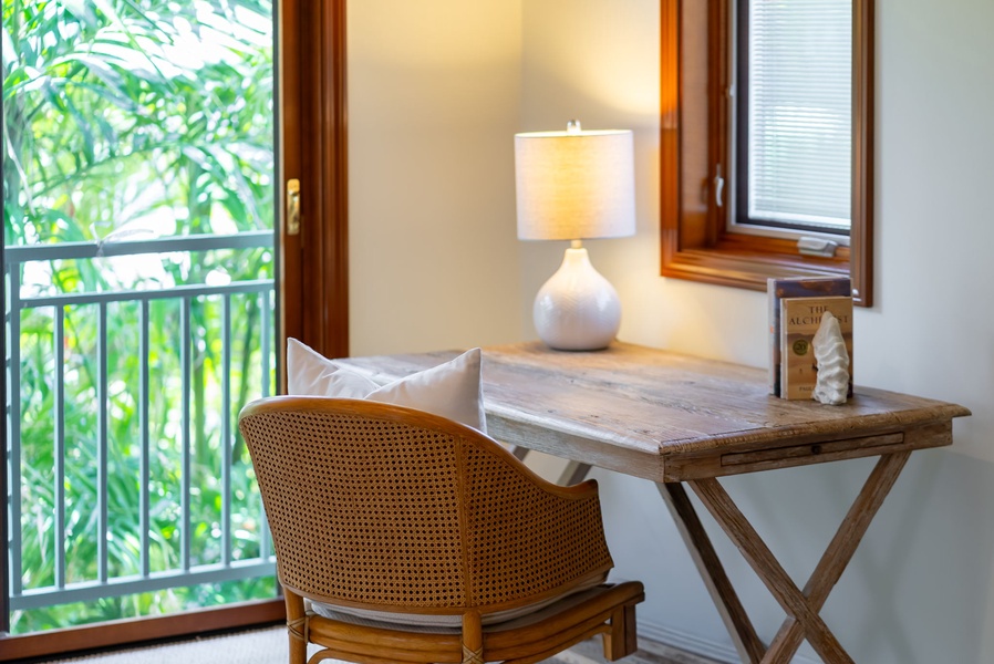Step into your peaceful corner workspace where natural light pours through the window, framing lush garden views that inspire relaxation and creativity throughout your stay.