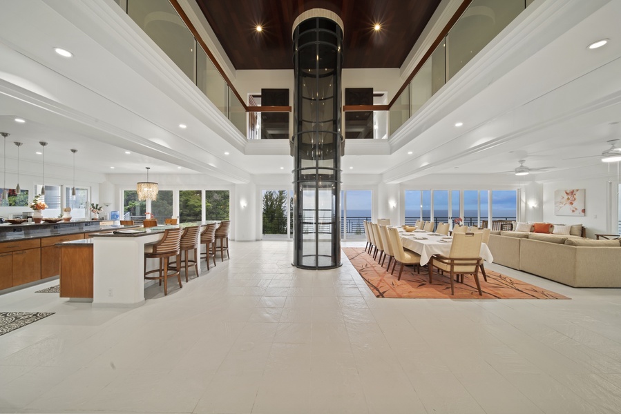 Great room (2nd floor) with wraparound lanai and elevator between the estate’s three stories.