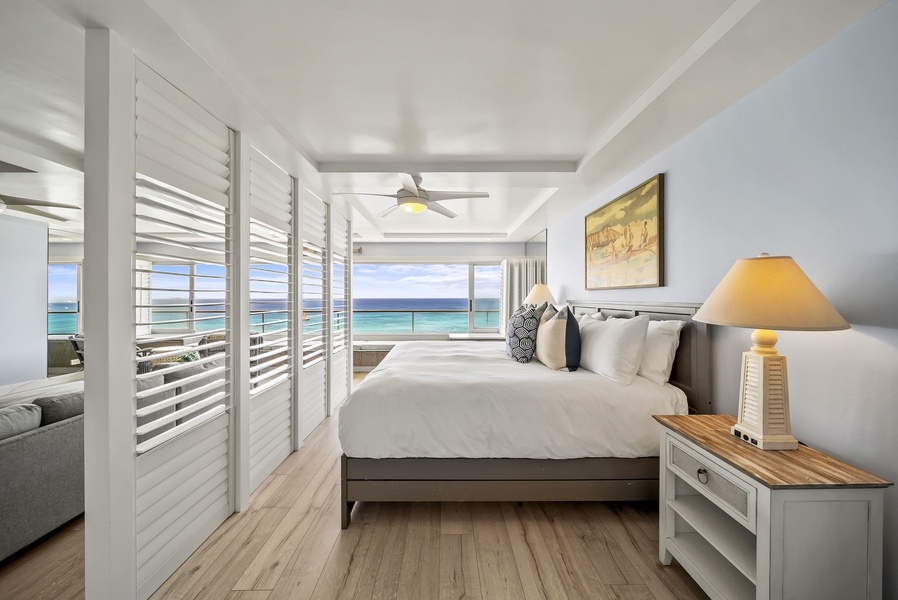 The expansive windows provide stunning ocean views in your bright, airy bedroom with modern comfort and coastal elegance.