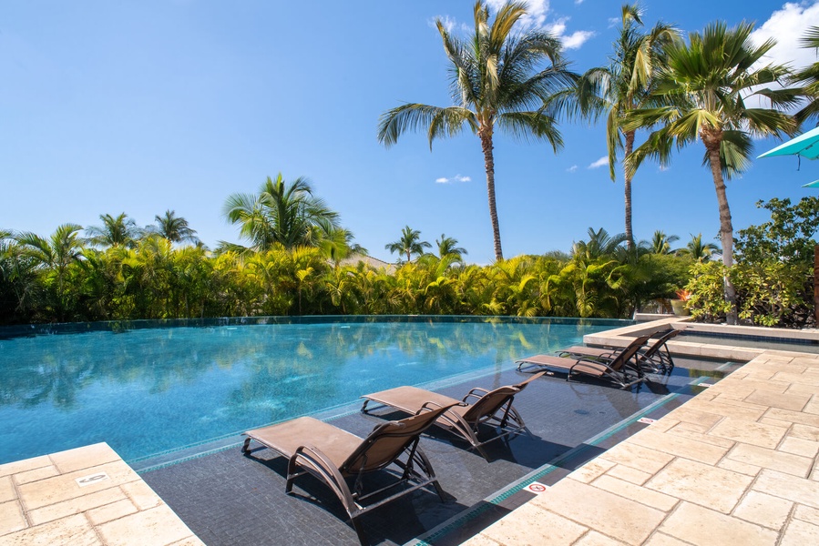 Soak in the shared spa while taking in serene ocean and mountain vistas from the elevated deck.
