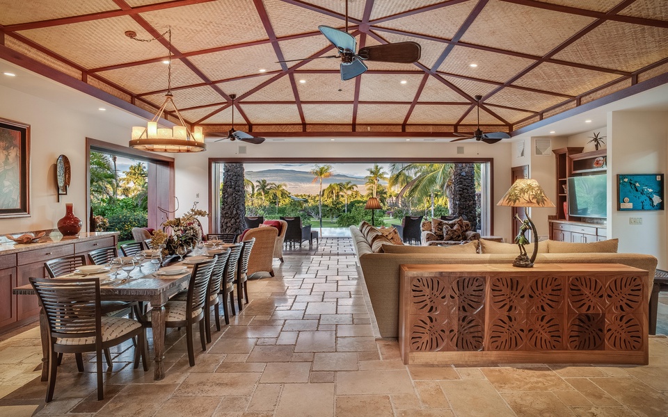 The open-concept great room w/ pocket doors leading to the lanai and the pool.